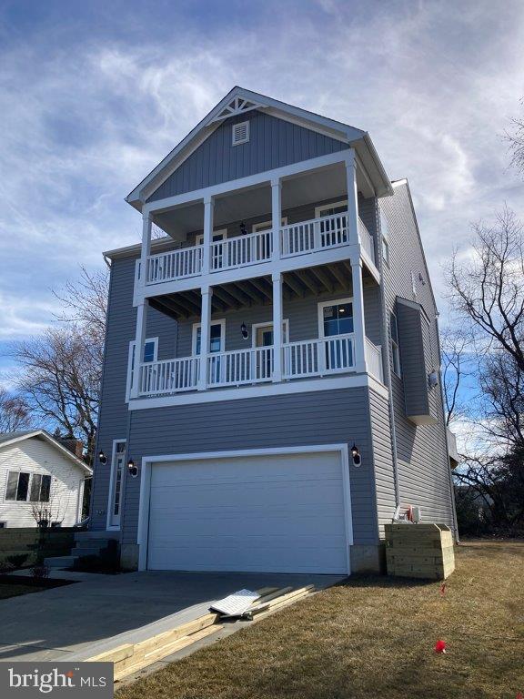 view of front of property with a balcony and a garage