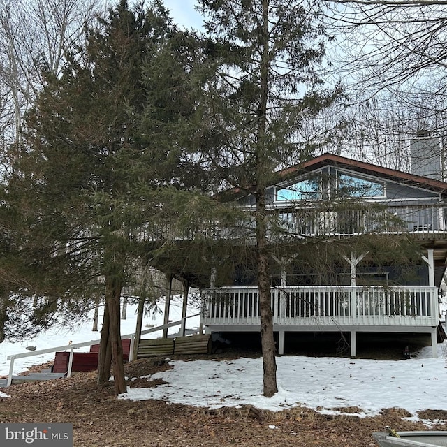 snow covered house with a deck