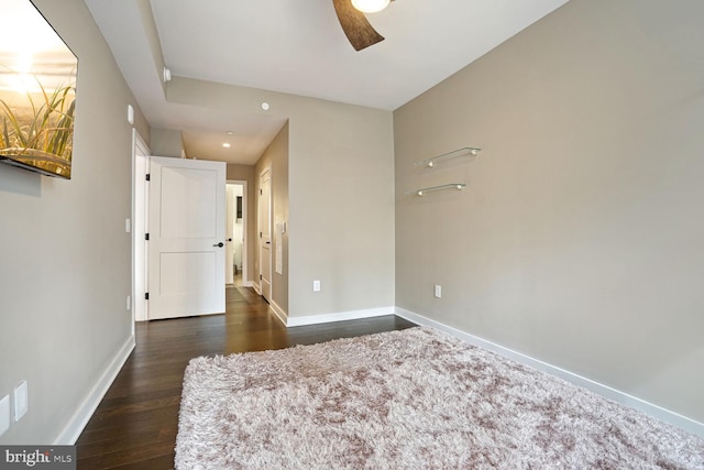 empty room featuring ceiling fan and dark hardwood / wood-style floors