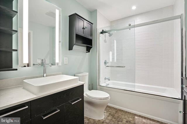 full bathroom featuring vanity, tile patterned flooring, shower / bath combination with glass door, and toilet