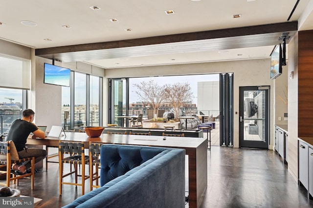 interior space featuring beamed ceiling and dark hardwood / wood-style floors