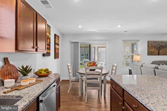 kitchen featuring light stone countertops, dishwasher, and dark hardwood / wood-style flooring