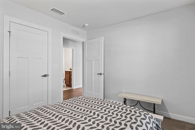 bedroom with dark colored carpet