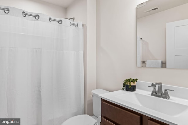 bathroom featuring large vanity and toilet