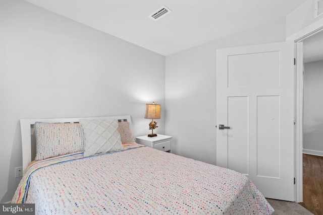 bedroom with dark wood-type flooring