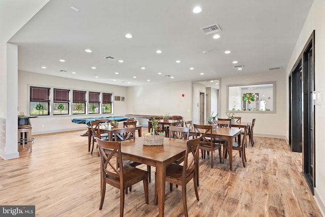 dining space featuring light wood-type flooring and billiards