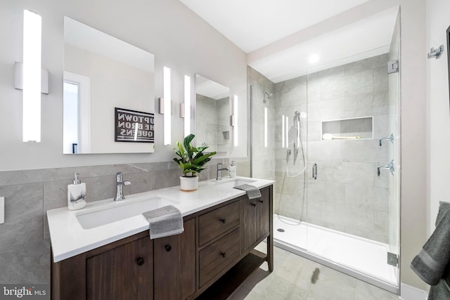 bathroom with double vanity, tile floors, and walk in shower