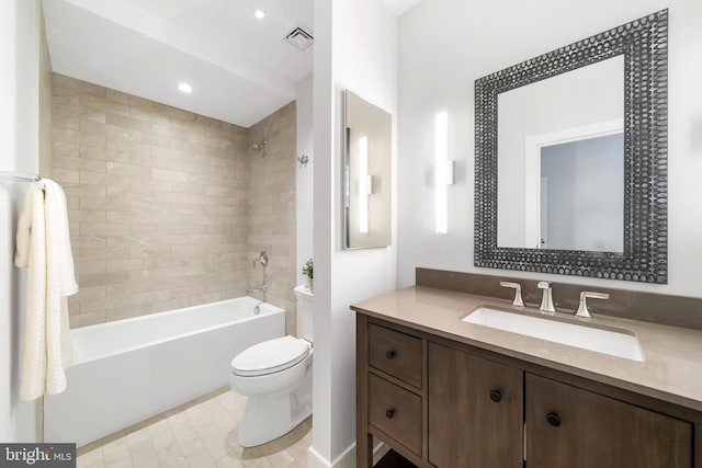 full bathroom featuring large vanity, toilet, tile floors, and tiled shower / bath