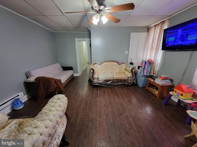 bedroom featuring ceiling fan, baseboard heating, a paneled ceiling, and dark hardwood / wood-style floors