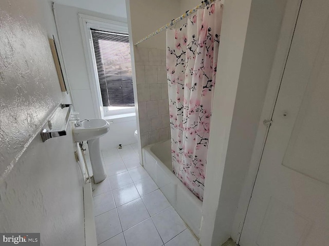 bathroom featuring shower / tub combo with curtain, tile floors, and sink