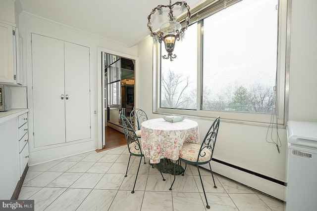 dining area featuring ornamental molding and baseboard heating