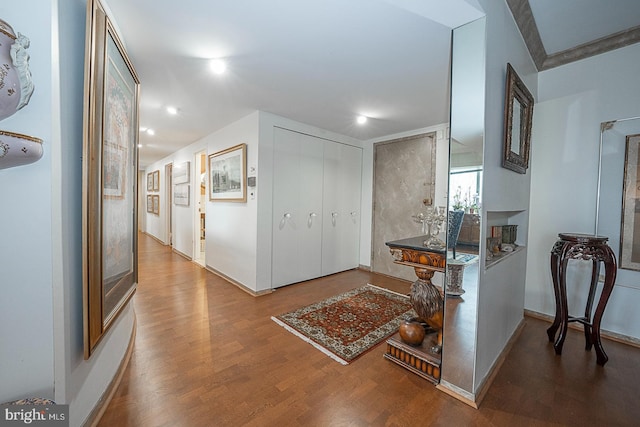 corridor with hardwood / wood-style flooring