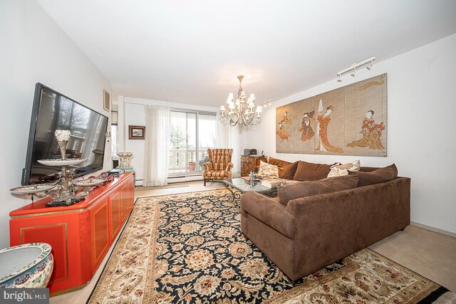 living room with light colored carpet, track lighting, baseboard heating, and a notable chandelier