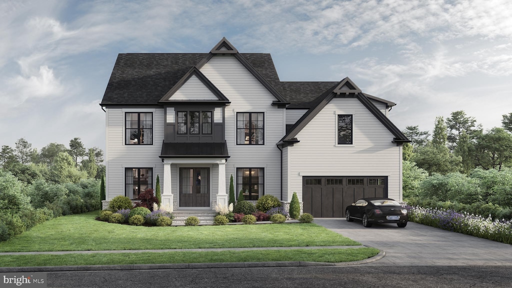 view of front of property featuring a garage and a front yard