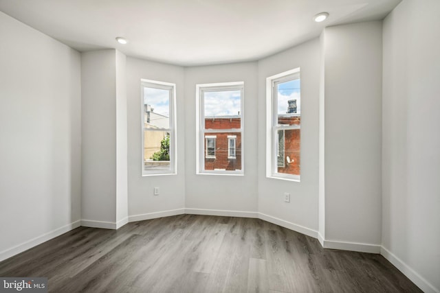 unfurnished room with recessed lighting, baseboards, and dark wood-style flooring