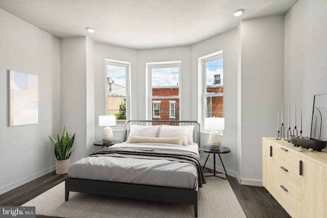 bedroom featuring dark wood-type flooring, recessed lighting, and baseboards