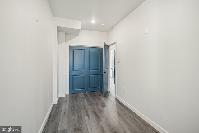 hall featuring wood finished floors and baseboards