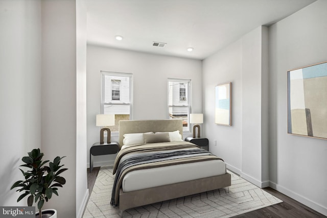 bedroom featuring visible vents, recessed lighting, baseboards, and wood finished floors