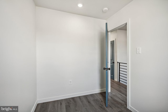 unfurnished room featuring baseboards and wood finished floors