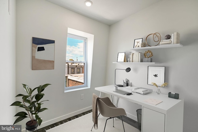 home office featuring baseboards and wood finished floors