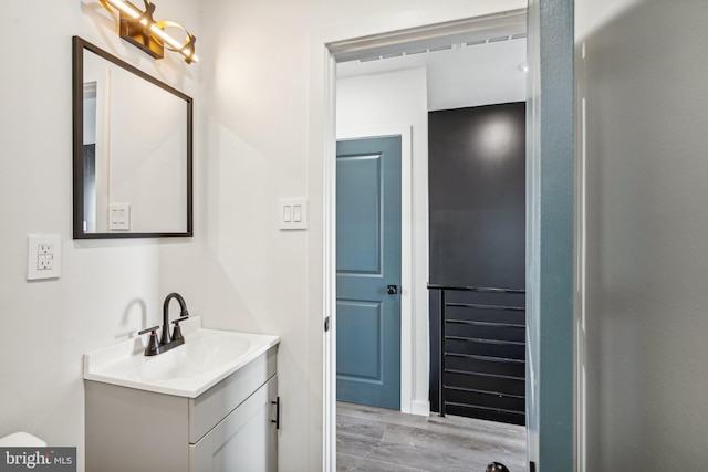 bathroom with vanity and wood finished floors