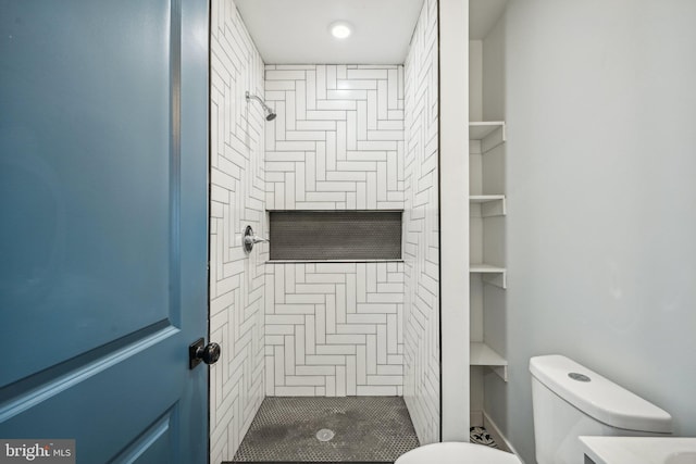 bathroom featuring a stall shower and toilet