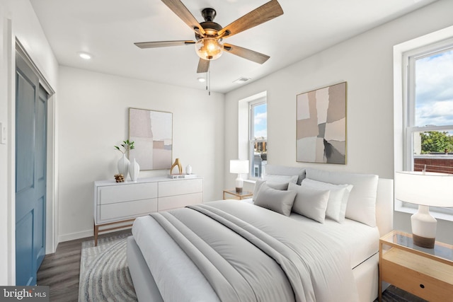 bedroom featuring wood finished floors, visible vents, baseboards, recessed lighting, and ceiling fan