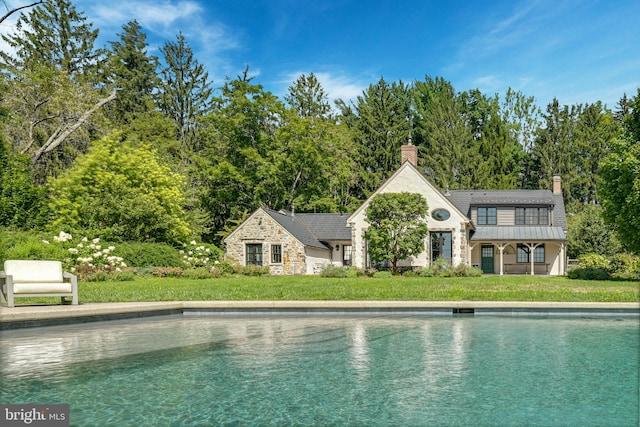 view of pool with a yard