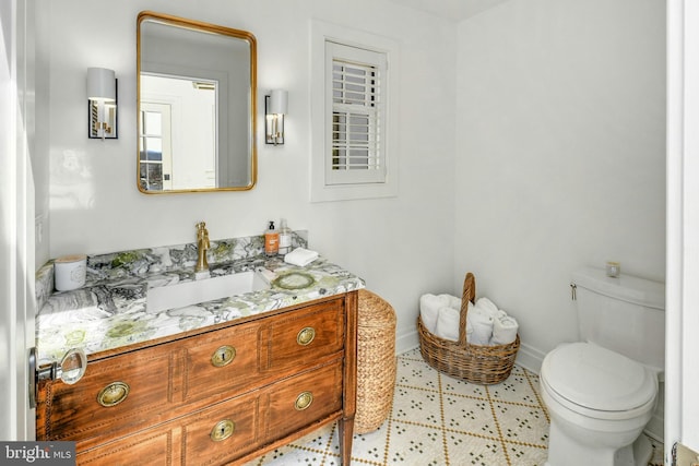 bathroom featuring toilet and vanity