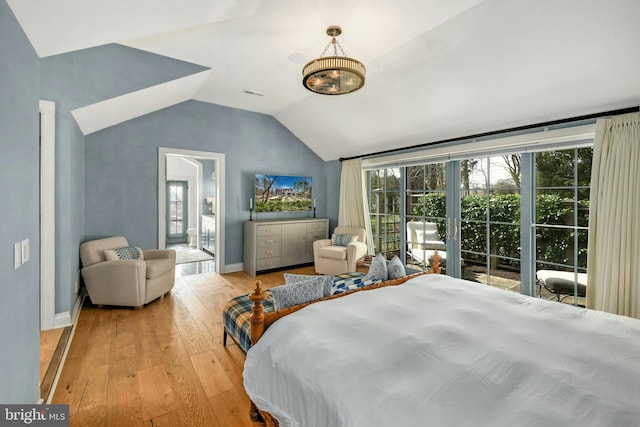 bedroom with vaulted ceiling and hardwood / wood-style flooring