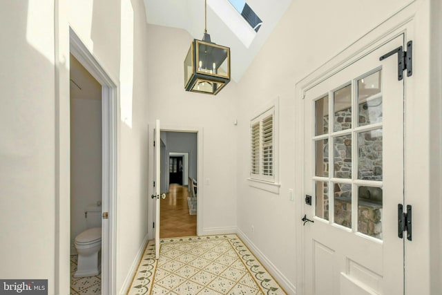 interior space with lofted ceiling and baseboards