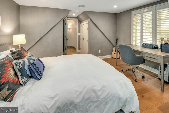 bedroom with light hardwood / wood-style flooring and a closet