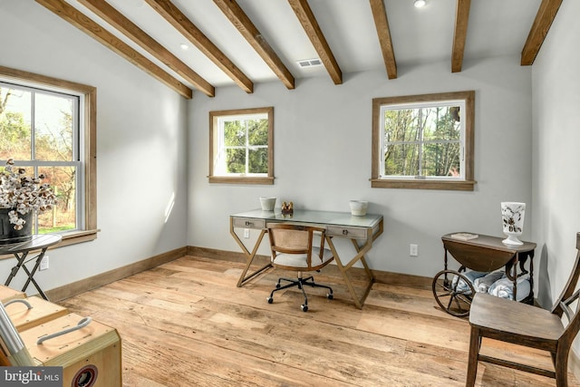 office area with light hardwood / wood-style floors, lofted ceiling with beams, and plenty of natural light