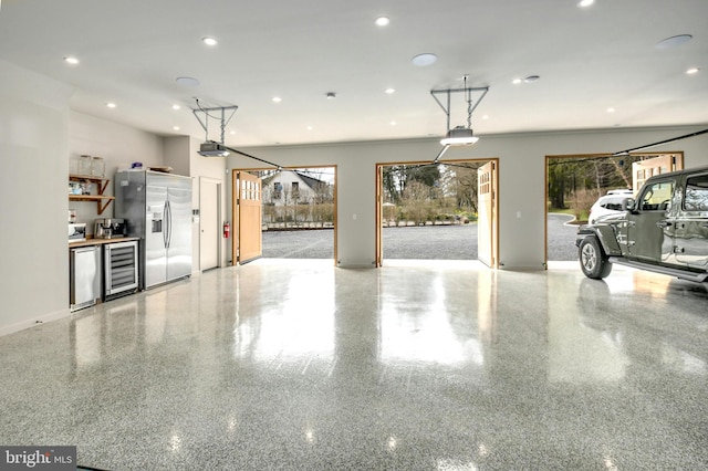 garage featuring stainless steel fridge and beverage cooler