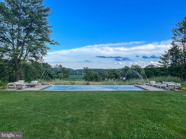 view of swimming pool with an outdoor living space, a yard, a patio area, and pool water feature