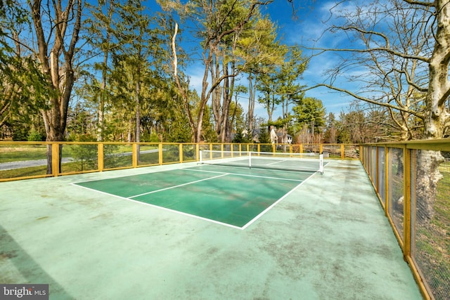 view of sport court featuring fence