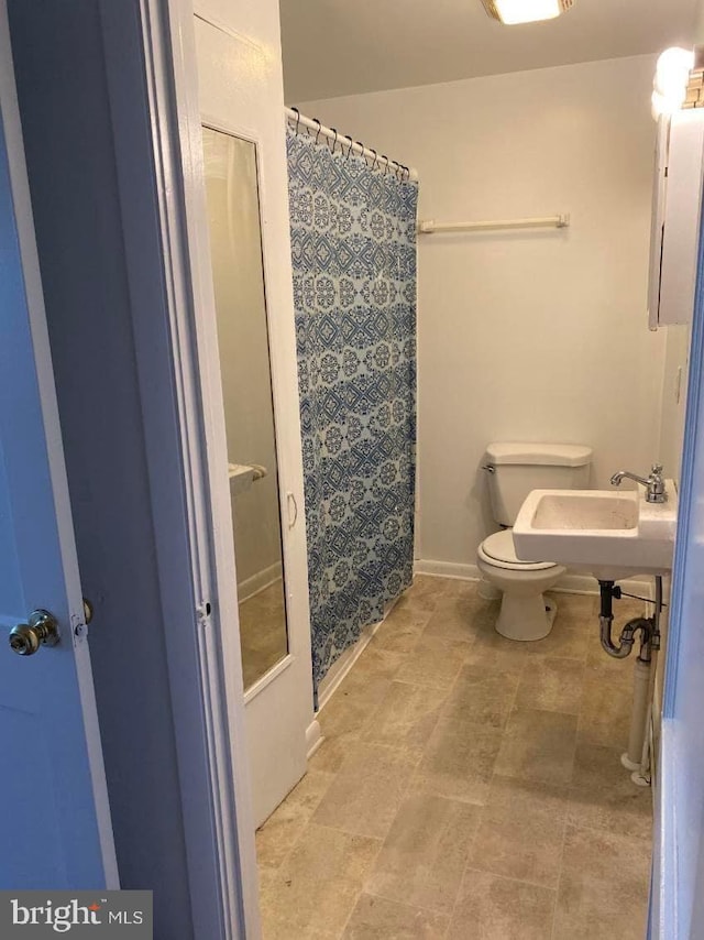 bathroom with toilet and tile flooring