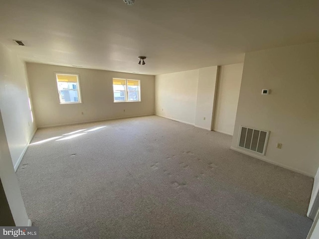 unfurnished room with light colored carpet