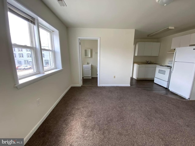 interior space featuring dark colored carpet and sink