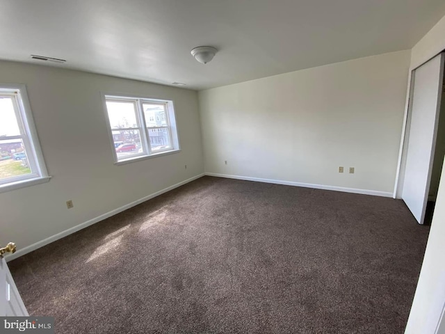 carpeted empty room with a wealth of natural light