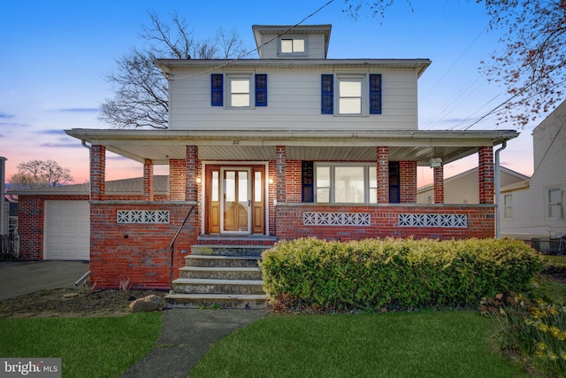 view of front of property featuring covered porch and a garage