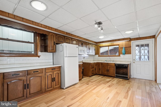 kitchen featuring white appliances, light wood-type flooring, a drop ceiling, and sink