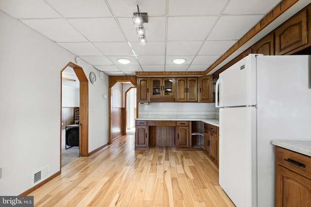 kitchen featuring a paneled ceiling, white fridge, and light hardwood / wood-style flooring