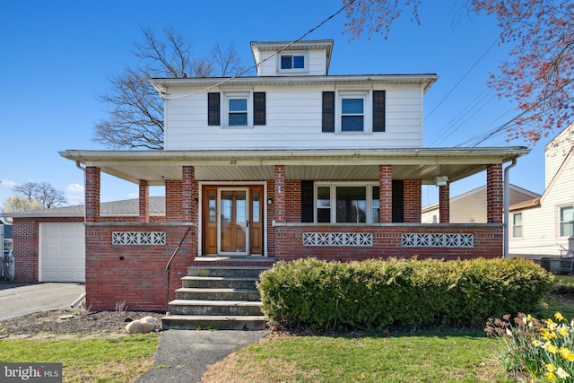 view of front facade featuring a porch and a garage