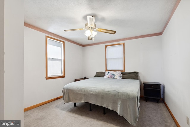 carpeted bedroom with ornamental molding, a textured ceiling, and ceiling fan