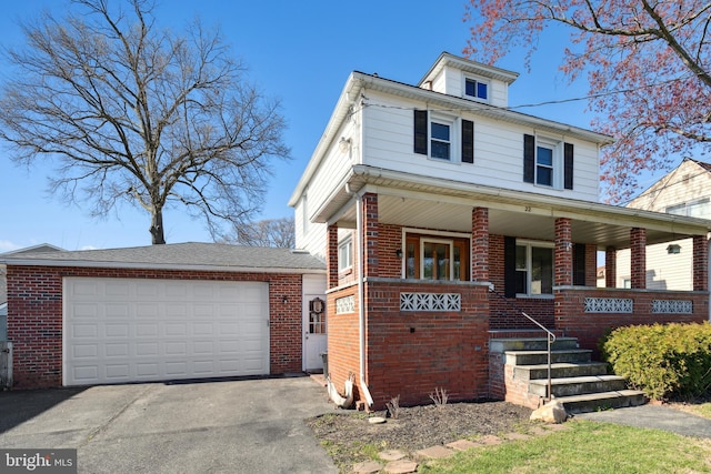 view of front of home with covered porch and a garage