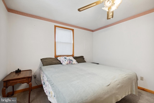 bedroom with ornamental molding, ceiling fan, and dark colored carpet