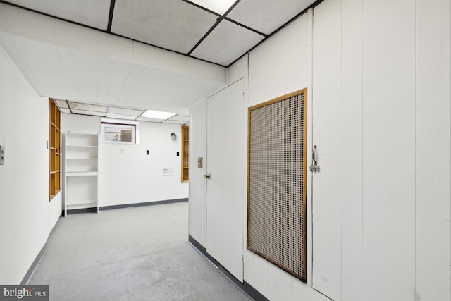 corridor with a paneled ceiling