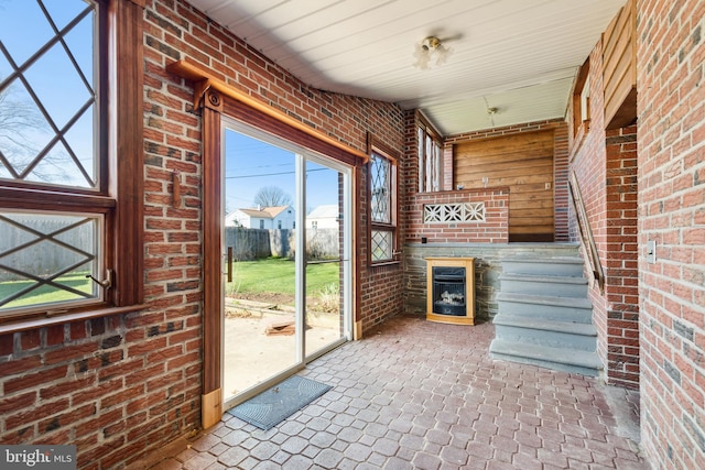 unfurnished sunroom with a fireplace