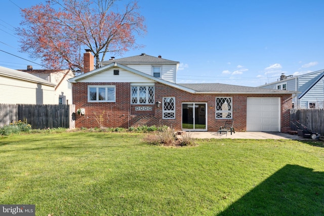 view of front of home with a front lawn and a garage